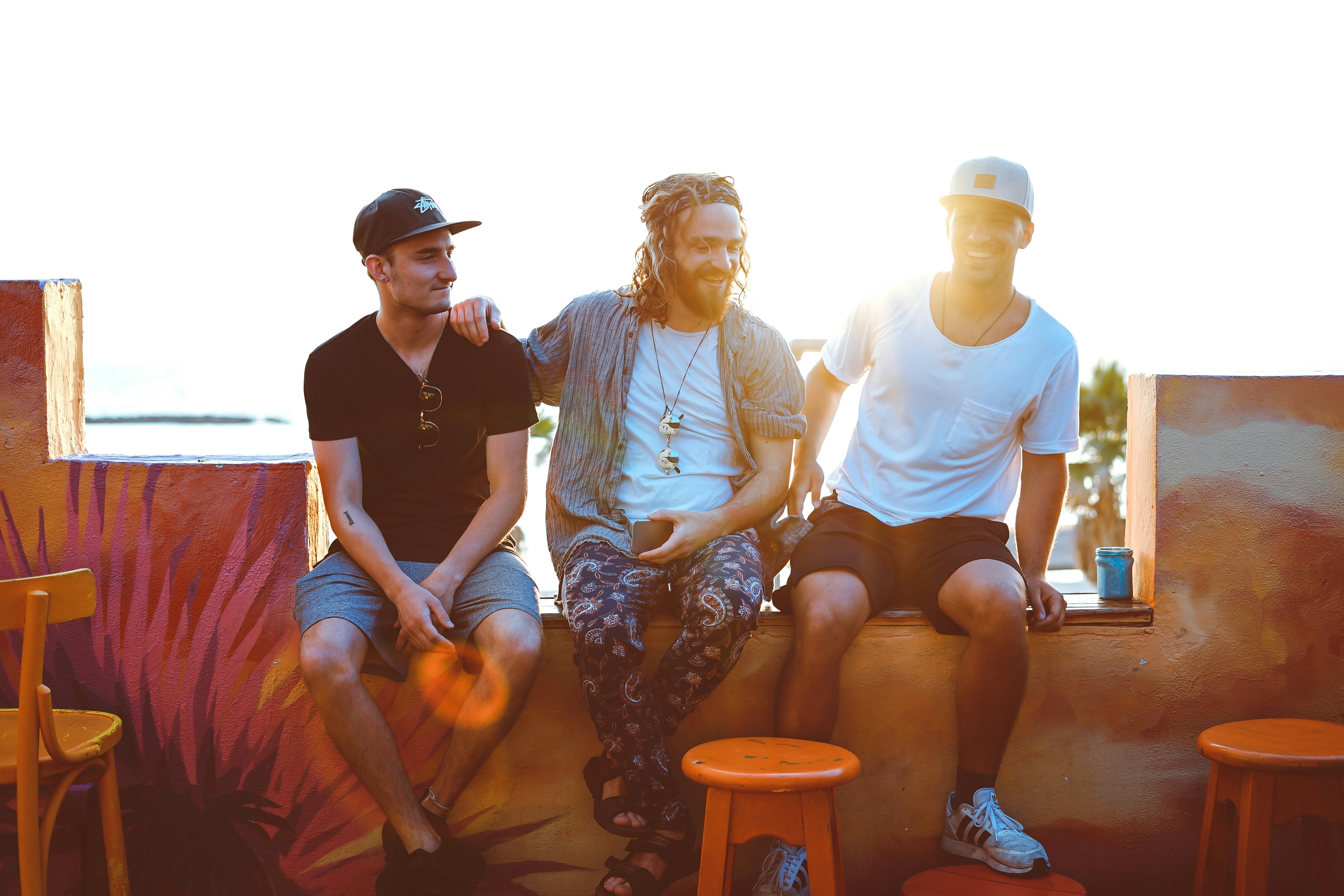 A small group of men sitting together, laughing in conversation